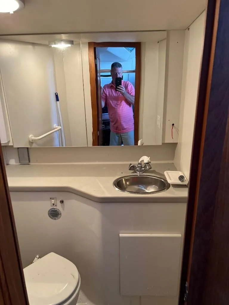 Slide: The Image of 1994 Carver 355 Aft Cabin bathroom with sink, mirror, and toilet. - 20