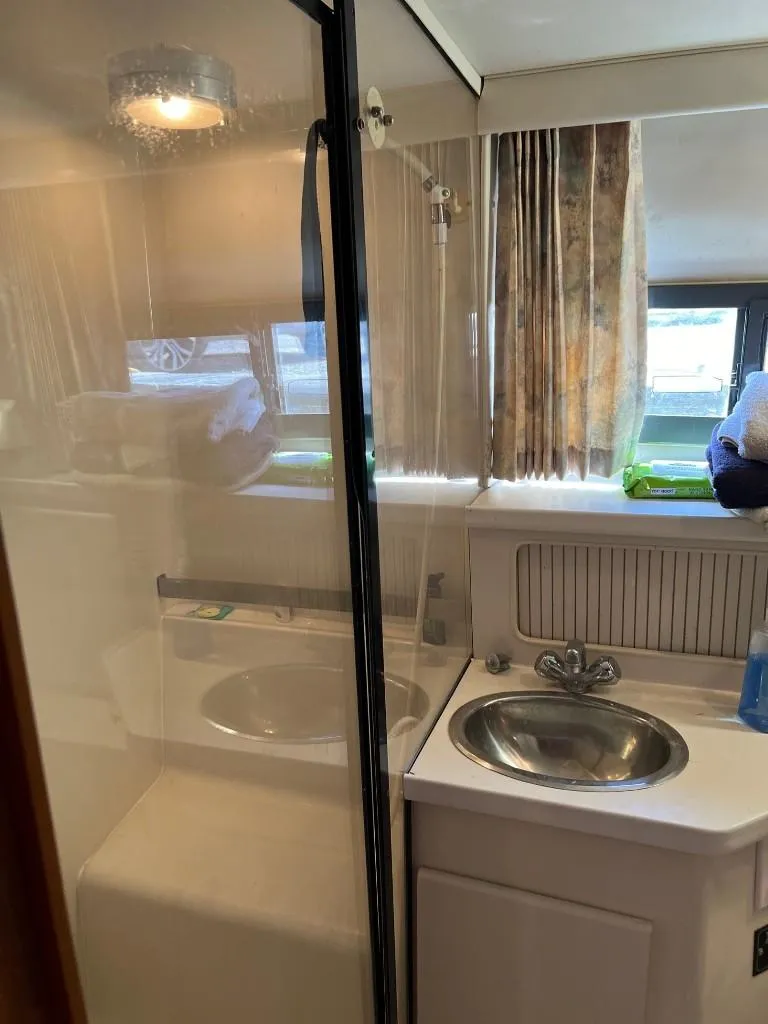 Slide: The Image of 1994 Carver 355 Aft Cabin bathroom with shower and sink. - 25