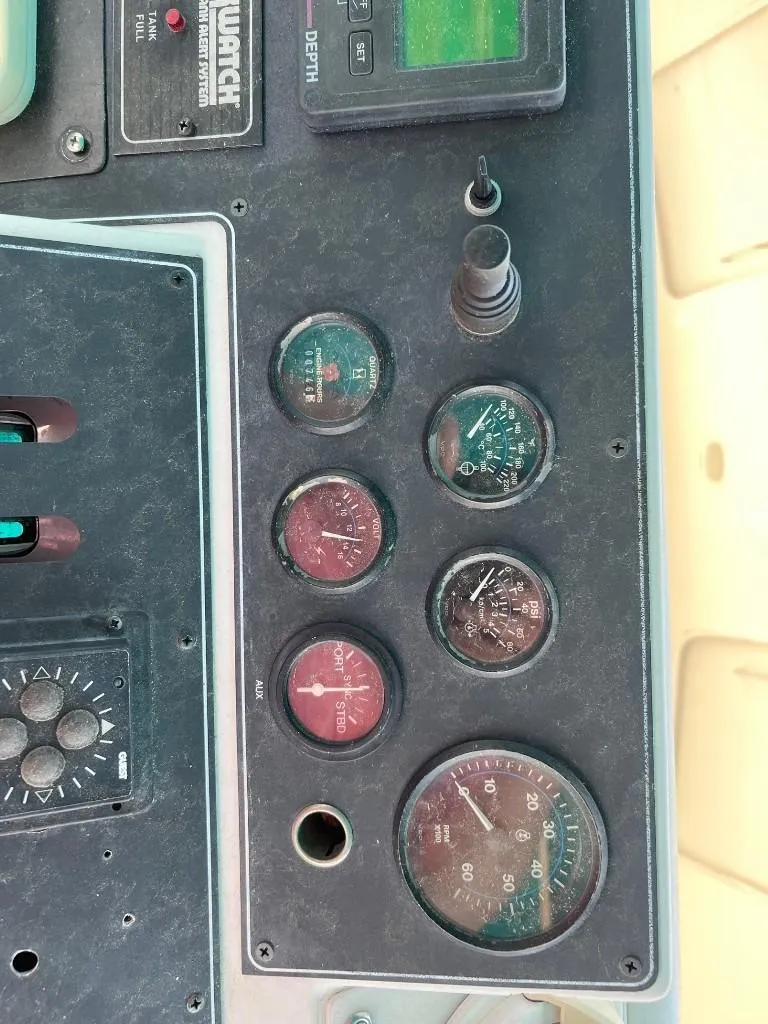 Slide: The Image of Control panel of a 1994 Carver 355 Aft Cabin boat with various gauges. - 5