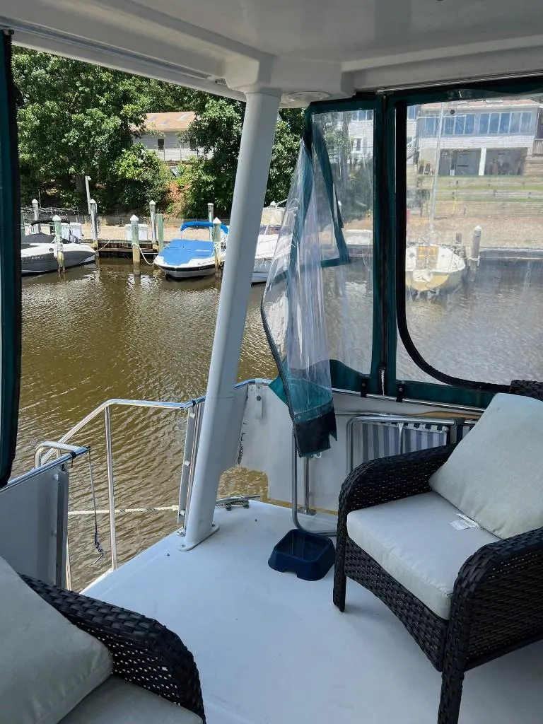 Slide: The Image of 1994 Carver 355 Aft Cabin boat interior with waterfront view. - 9