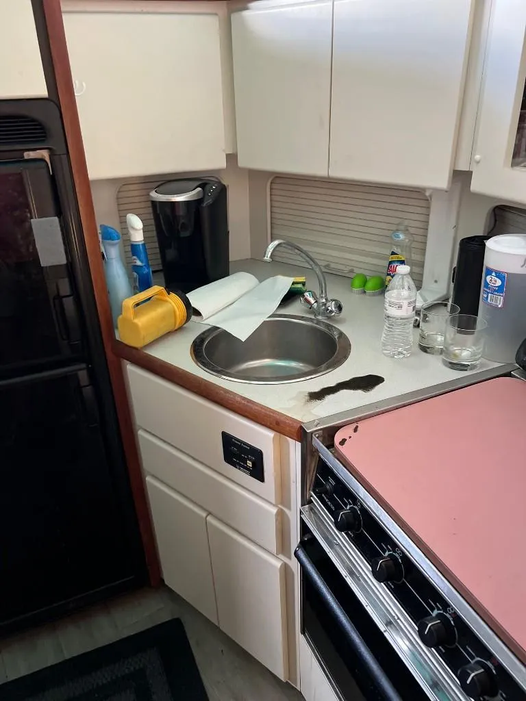 Slide: The Image of 1994 Carver 355 Aft Cabin kitchen with sink, stove, and appliances. - 18