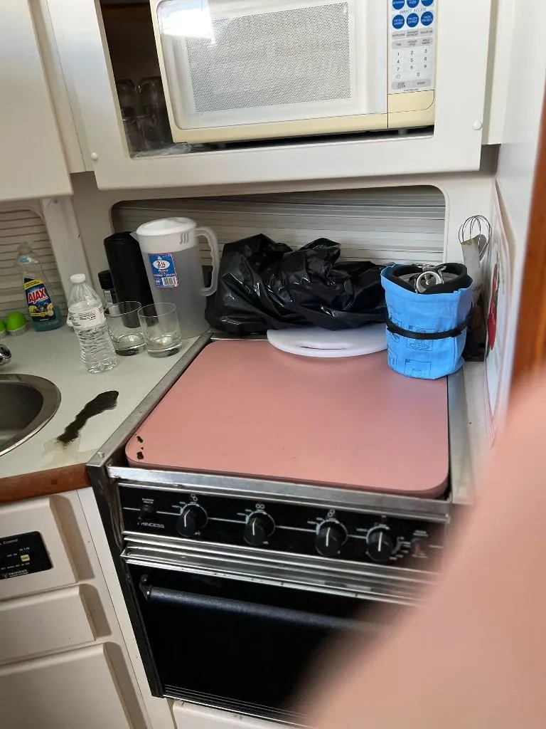 Slide: The Image of Compact kitchen area in a 1994 Carver 355 Aft Cabin boat. - 19