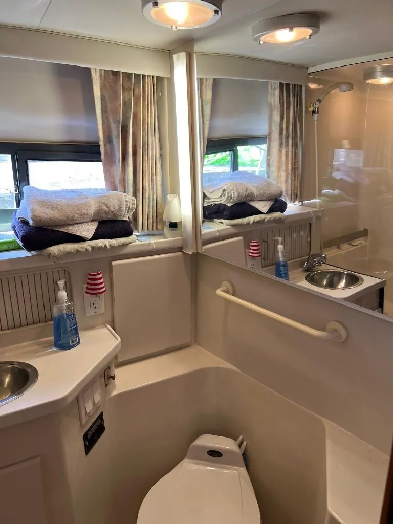 Slide: The Image of 1994 Carver 355 Aft Cabin bathroom with sink, toilet, and shower. - 24