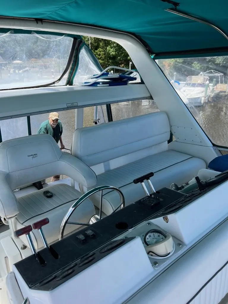 Slide: The Image of 1994 Carver 355 Aft Cabin boat interior with helm and seating. - 6