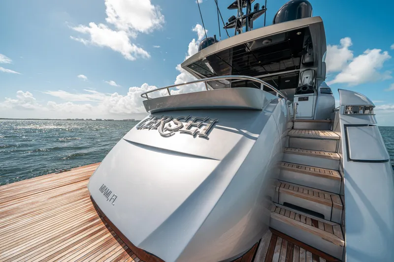 Slide: The Image of Luxury Pershing 92 yacht, 2012 model, docked on a sunny day with wooden deck and ocean view. - 15