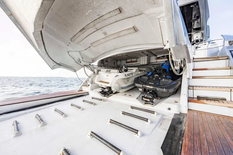Slide: The Image of 2012 Pershing 92 yacht with open garage, revealing stored jet skis and equipment. - 17
