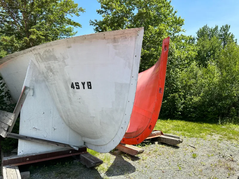 The Image of Boat hull molds by Young Brothers, 2020, displayed outdoors with trees in the background. - 0