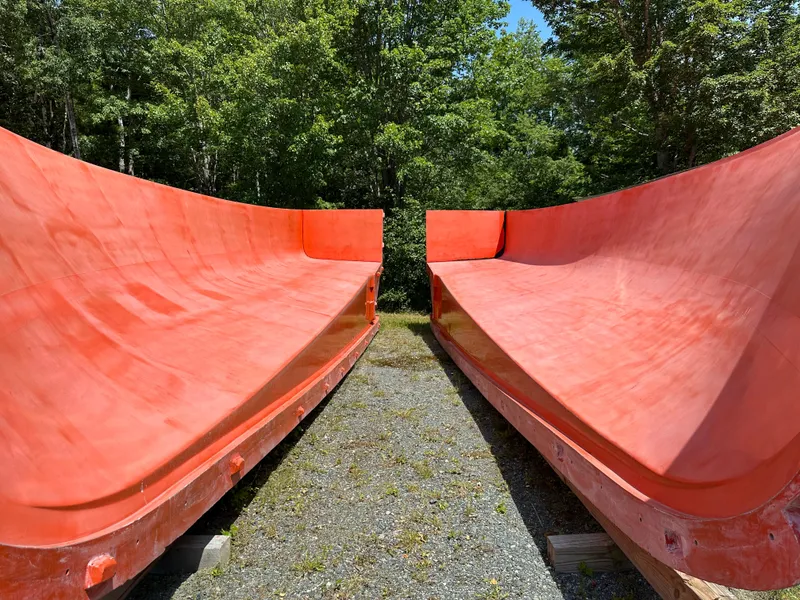 Slide: The Image of Red hull molds by Young Brothers, 2020, outdoors with trees in the background. - 9