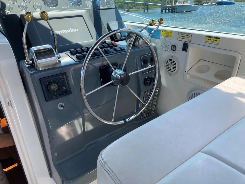 Slide: The Image of Steering console of a 2002 Tiara Yachts 3100 Open with Raymarine electronics. - 3