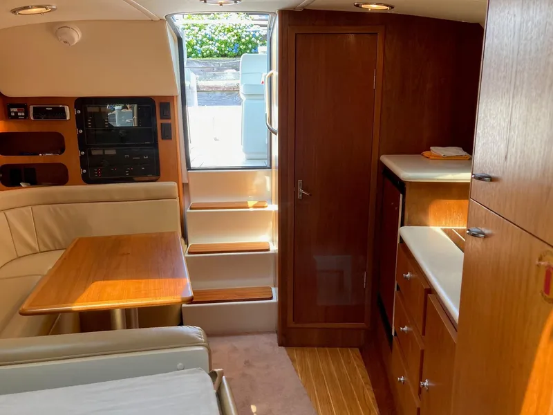 Slide: The Image of Interior of 2002 Tiara Yachts 3100 Open with wooden cabinetry and seating area. - 5