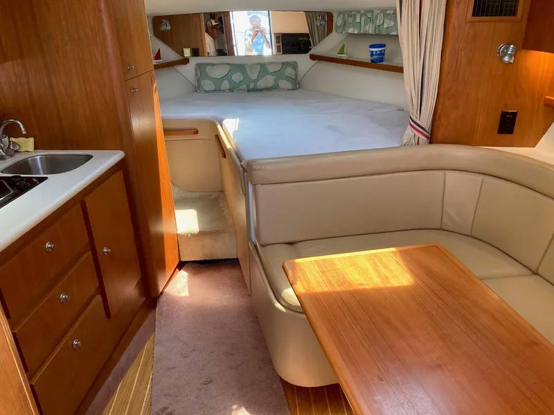 Slide: The Image of Interior of a 2002 Tiara Yachts 3100 Open with bed, kitchenette, and seating area. - 7