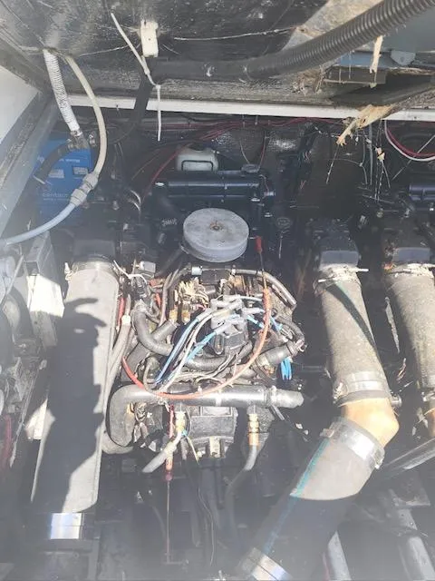 Slide: The Image of 1999 Shamrock 290 Walkaround boat engine compartment with visible wiring and components. - 12