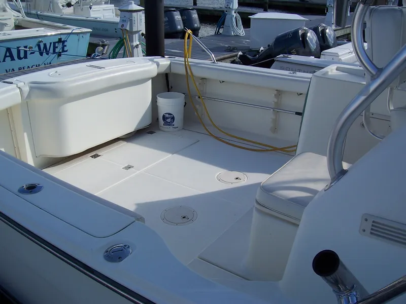 Slide: The Image of 1999 Shamrock 290 Walkaround boat interior, clean deck, docked at marina. - 8