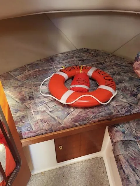 Slide: The Image of 1999 Shamrock 290 Walkaround cabin interior with life preserver. - 9