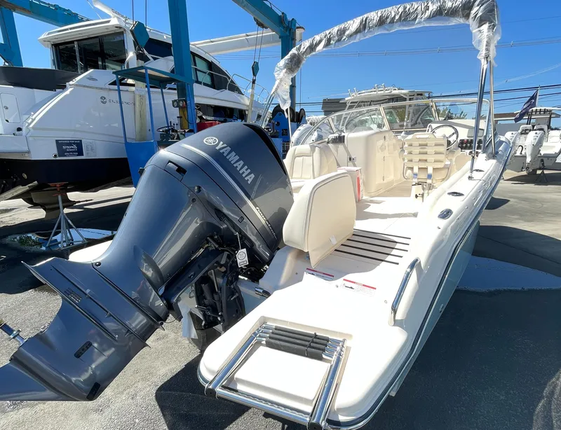 Slide: The Image of 2025 Grady-White Freedom 215 boat with Yamaha outboard motor in marina. - 2