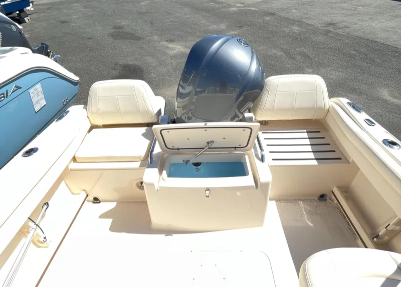 Slide: The Image of 2025 Grady-White Freedom 215 boat with open storage compartment and outboard motor. - 3