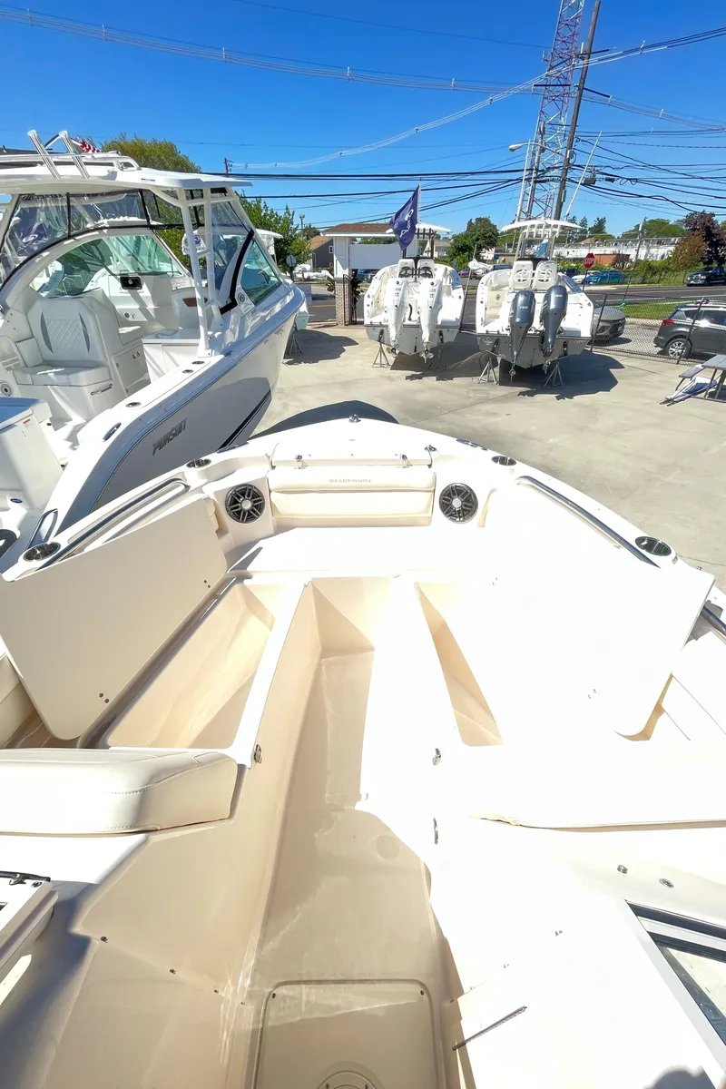 Slide: The Image of 2025 Grady-White Freedom 215 boat interior, docked with other boats. - 6
