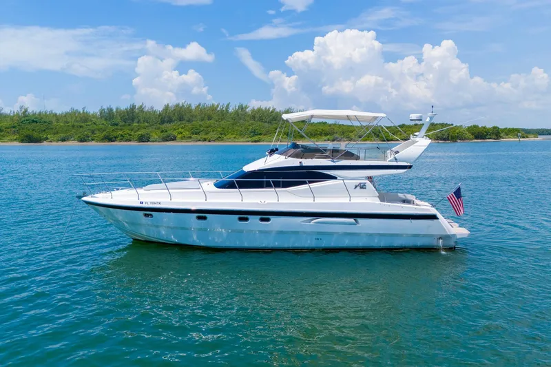 The Image of Azimut 43 Fly 1998 yacht on calm water with clear sky background. - 1