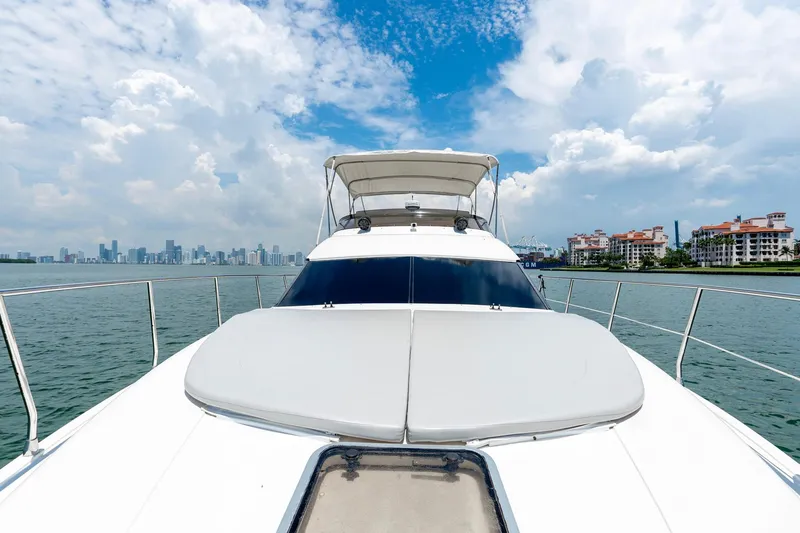 Slide: The Image of Azimut 43 Fly yacht cruising on a sunny day, city skyline in background. - 14