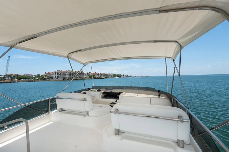 Slide: The Image of Flybridge view of 1998 Azimut 43 Fly yacht with ocean backdrop. - 18