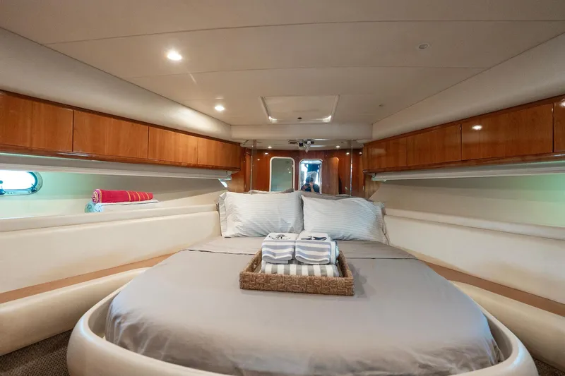 Slide: The Image of Luxurious cabin interior of 1998 Azimut 43 Fly yacht with cozy bed and elegant wood finish. - 28
