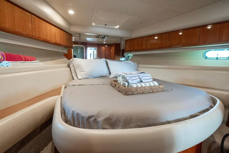 Slide: The Image of Luxurious bedroom interior of 1998 Azimut 43 Fly yacht with cozy bed and elegant wood finishes. - 30