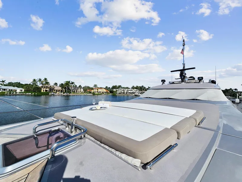 Slide: The Image of Palmer Johnson 120 Sports Cruiser 2008 yacht with sunbathing deck, docked by waterfront homes. - 11