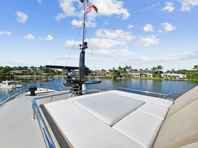 Slide: The Image of 2008 Palmer Johnson 120 Sports Cruiser yacht with sunbathing deck on a serene waterfront. - 13