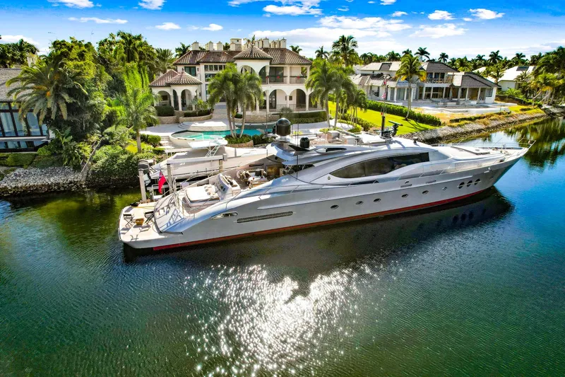 Slide: The Image of Palmer Johnson 120 Sports Cruiser 2008 yacht docked by luxurious waterfront mansion. - 2
