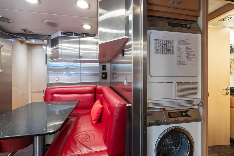 Slide: The Image of Interior of 2008 Palmer Johnson 120 Sports Cruiser with red seating and laundry area. - 37