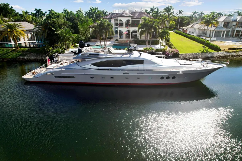 Slide: The Image of Palmer Johnson 120 Sports Cruiser 2008 yacht docked near a luxurious waterfront mansion. - 5