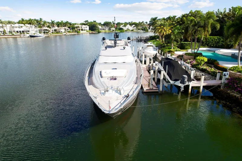 Slide: The Image of Palmer Johnson 120 Sports Cruiser 2008 docked in a scenic waterfront area. - 9