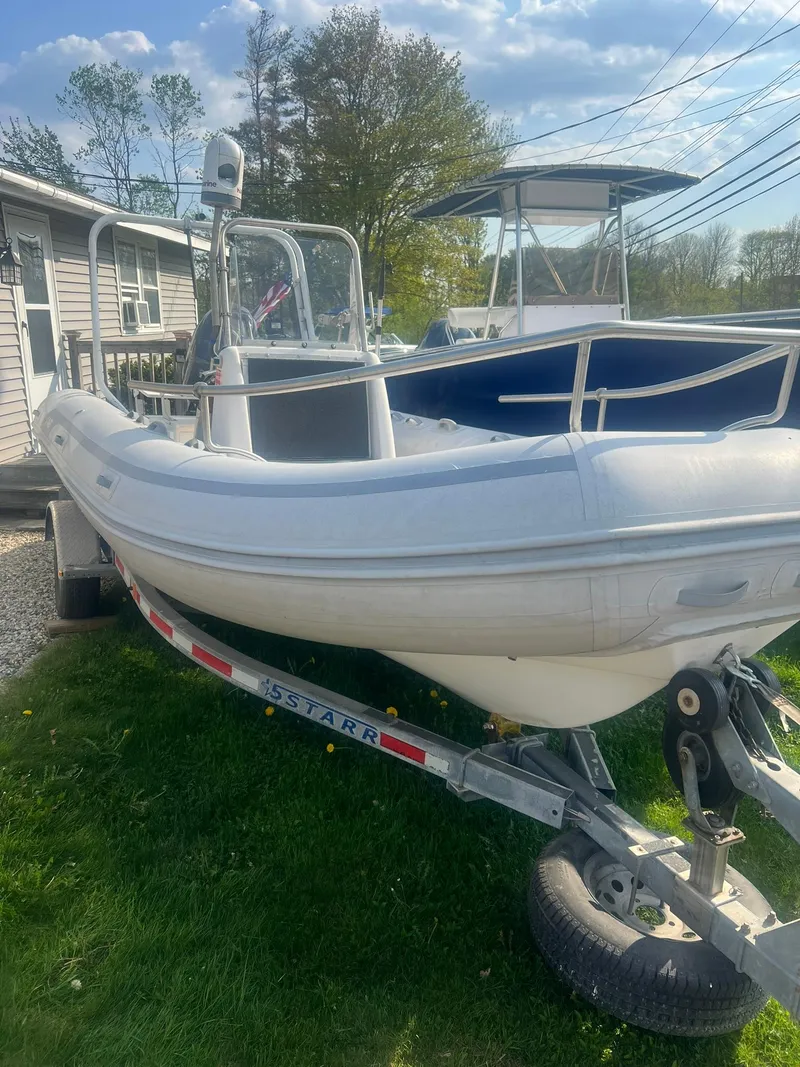 Slide: The Image of 2004 AB 570 VST inflatable boat on trailer in a yard. - 4