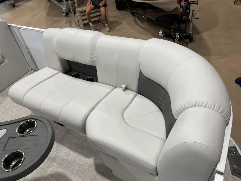 Slide: The Image of 2024 SunCatcher Fusion 324SS boat interior with plush seating and cup holders. - 10