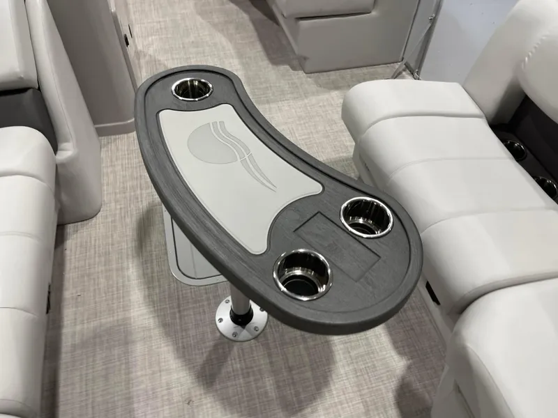 Slide: The Image of 2024 SunCatcher Fusion 324SS interior with a modern table and cup holders. - 11