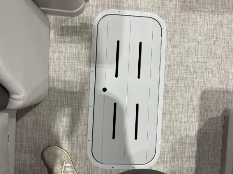 Slide: The Image of 2024 SunCatcher Fusion 324SS boat floor hatch with textured flooring. - 12