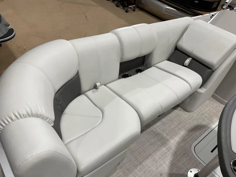 Slide: The Image of 2024 SunCatcher Fusion 324SS boat interior seating with plush white and gray upholstery. - 13