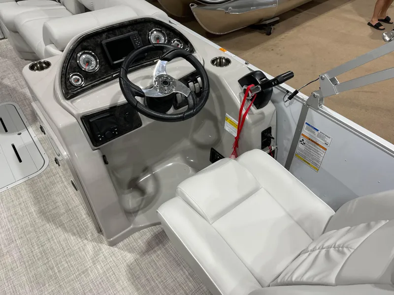Slide: The Image of 2024 SunCatcher Fusion 324SS boat cockpit with steering wheel and control panel. - 15