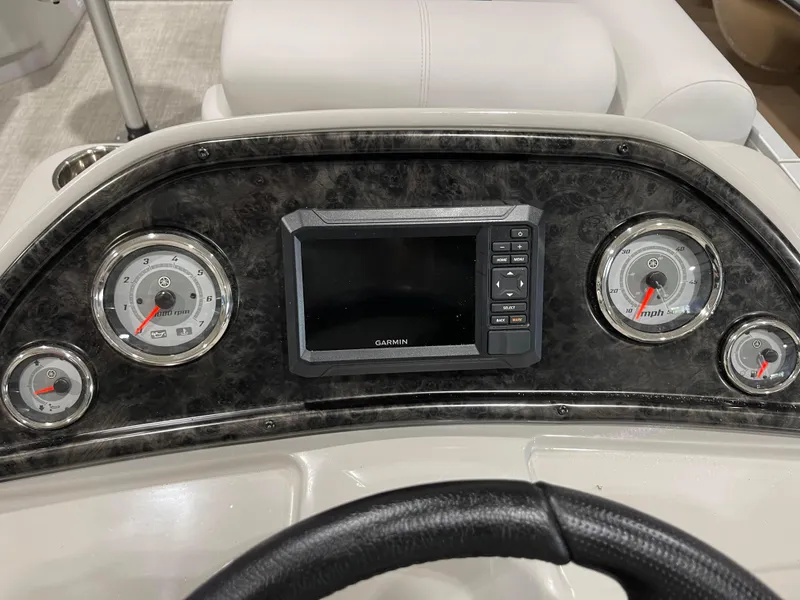 Slide: The Image of 2024 SunCatcher Fusion 324SS dashboard with Garmin display and gauges. - 16