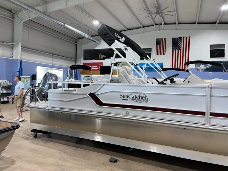 Slide: The Image of 2024 SunCatcher Fusion 324SS pontoon boat on display in showroom. - 4