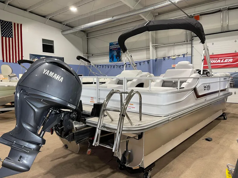 Slide: The Image of 2024 SunCatcher Fusion 324SS pontoon boat with Yamaha outboard motor in showroom. - 5