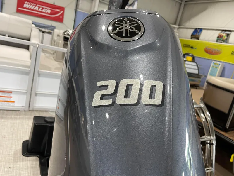 Slide: The Image of 2024 SunCatcher Fusion 324SS with Yamaha 200 outboard motor in showroom. - 6