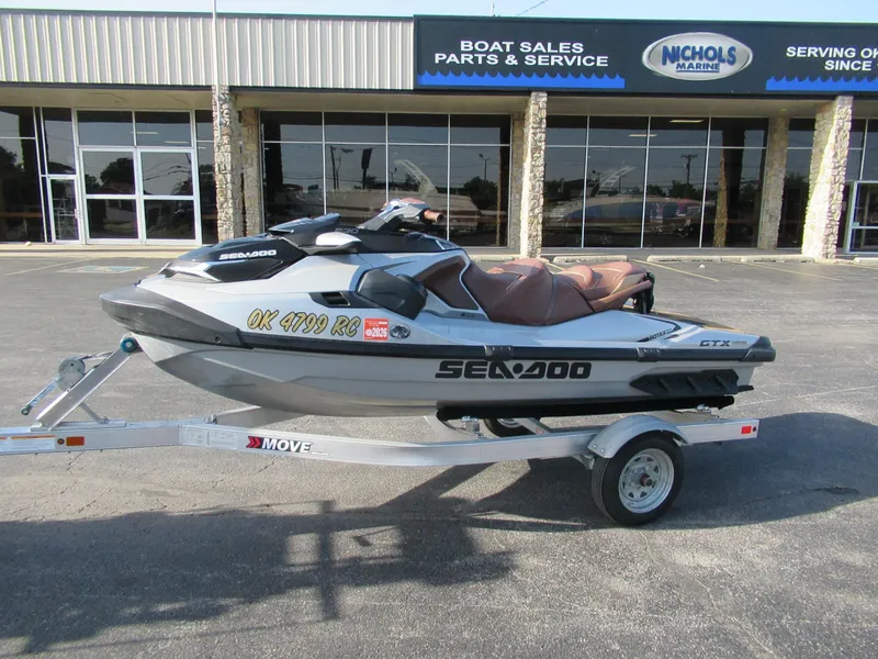 Slide: The Image of 2018 Bombardier SeaDoo GTX 230 Li on trailer outside boat sales and service shop. - 0
