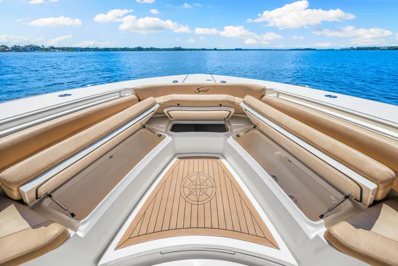 Slide: The Image of 2018 Scout 380 LXF boat interior with tan seating and wooden deck. - 32