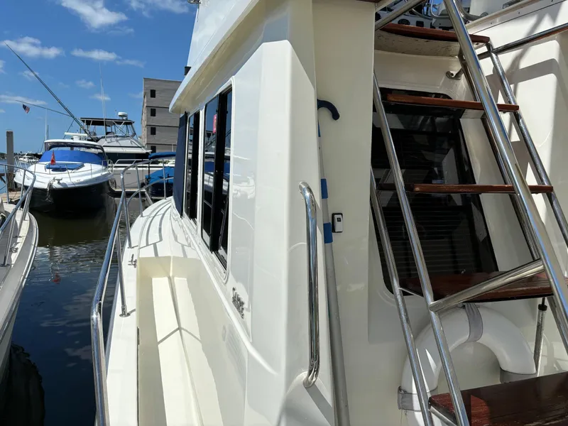 Slide: The Image of 2004 Sabreline 36 Sedan yacht docked at marina with blue sky background. - 19