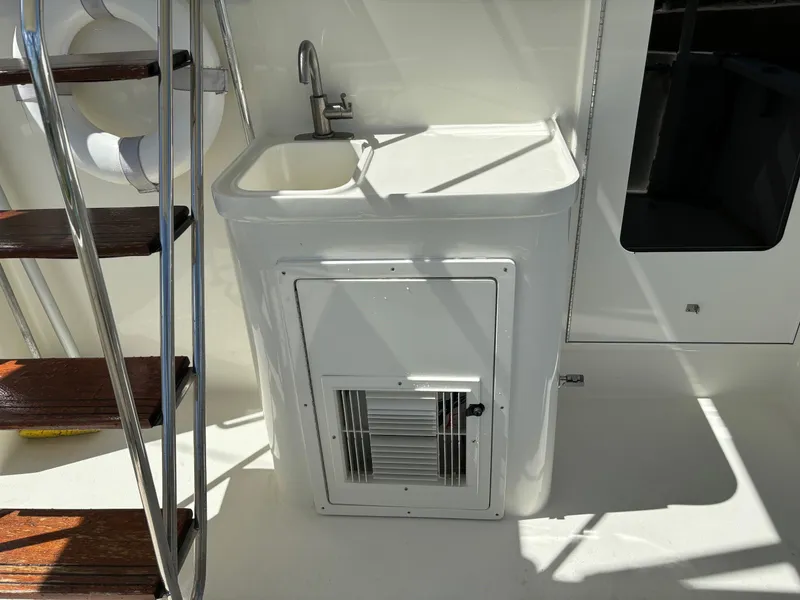 Slide: The Image of 2004 Sabreline 36 Sedan boat interior with sink and wooden stairs. - 21