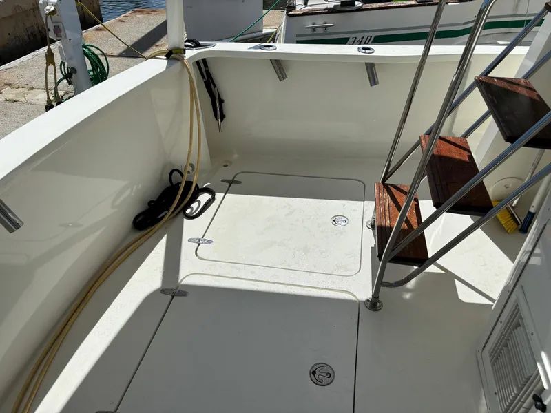 Slide: The Image of 2004 Sabreline 36 Sedan boat deck with wooden steps and storage hatch. - 22