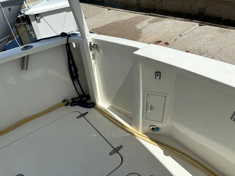 Slide: The Image of 2004 Sabreline 36 Sedan boat deck with storage compartments and yellow rope. - 24