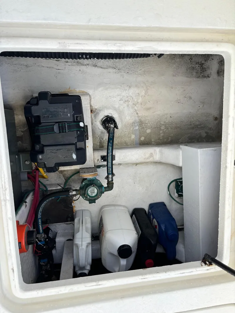Slide: The Image of 2004 Sabreline 36 Sedan engine compartment with various components and containers. - 27