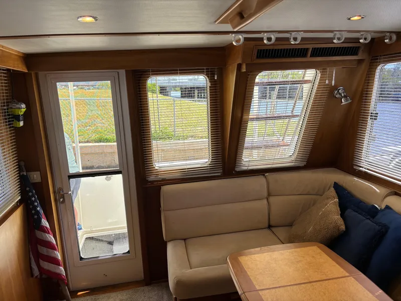 Slide: The Image of Interior of 2004 Sabreline 36 Sedan with beige seating and large windows. - 36